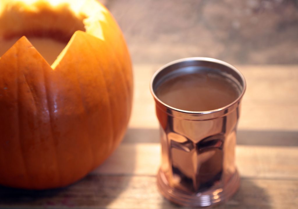 pumpkin spice punch served from a pumpkin for your halloween party